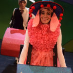 Al Kroeten and Miriam Gutierrez in Go Dog Go, dressed in dog costumes inside tiny cartoon cars