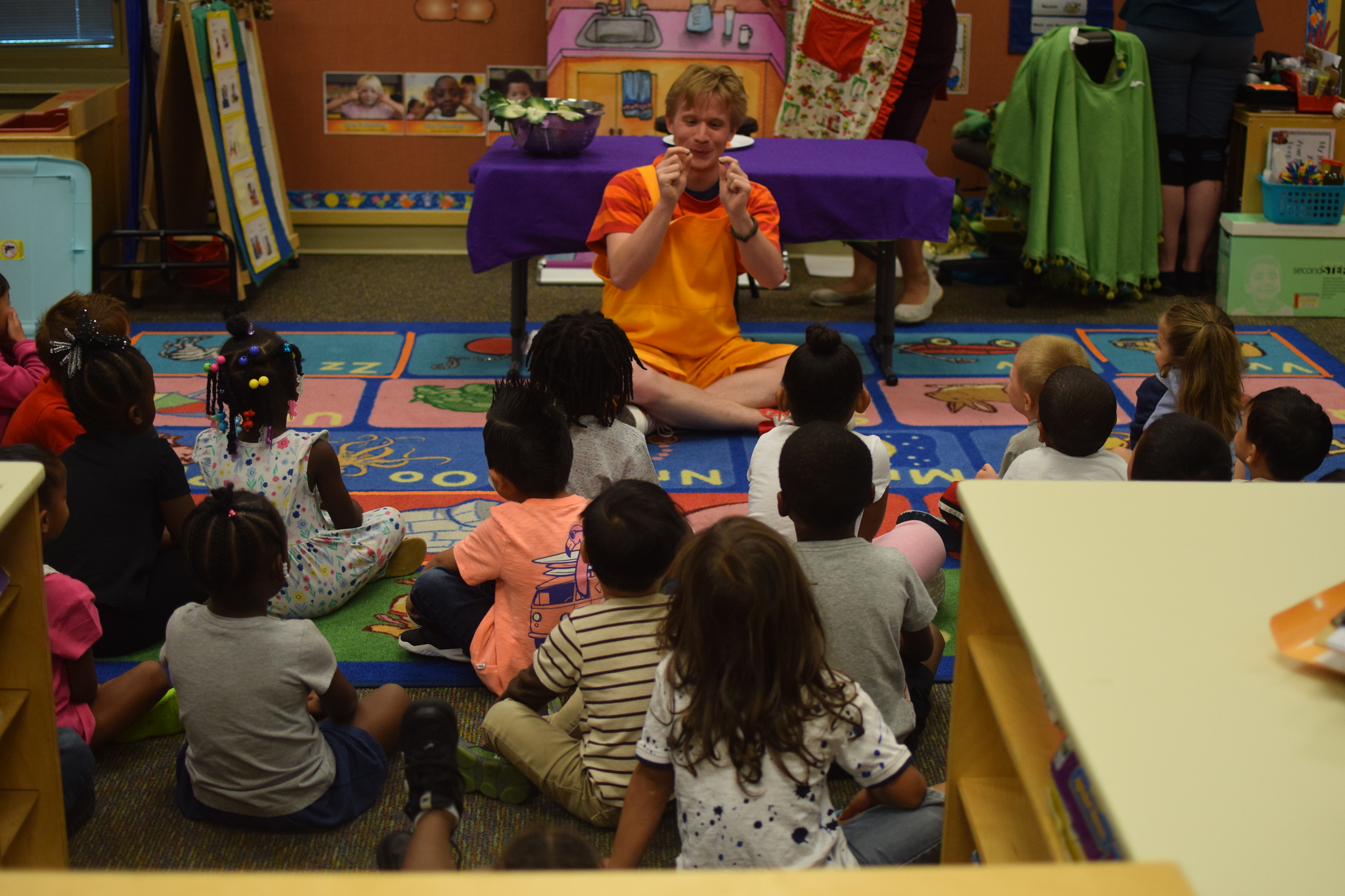 A Rose Teaching Artist leading a group of captive school students through a Rose Workshop.