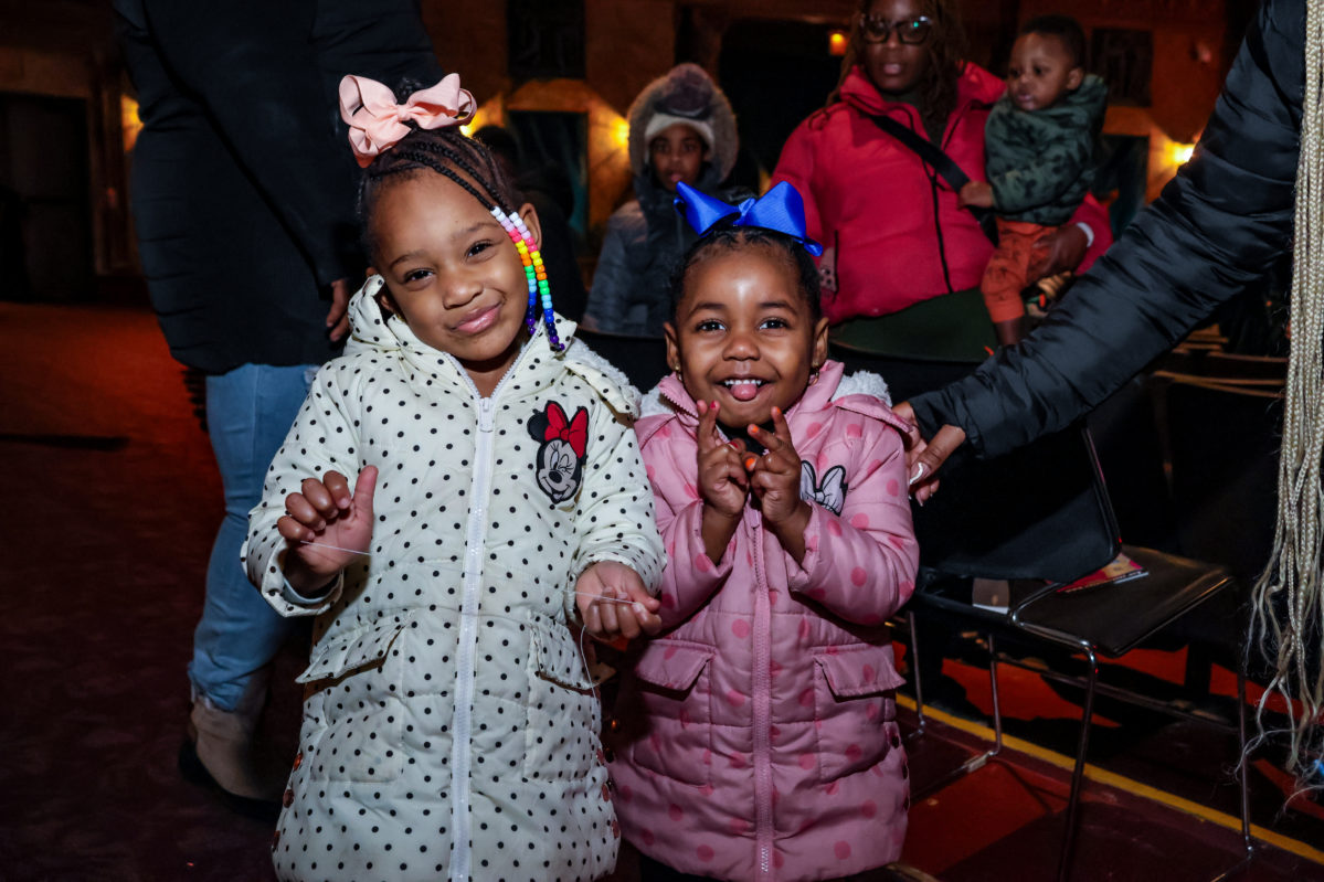 Two small children enjoying themselves at a Rose event.